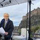 Wolf Blitzer sitting on the set in front of Edinburgh Castle, which is located 47 miles from Glasgow.
